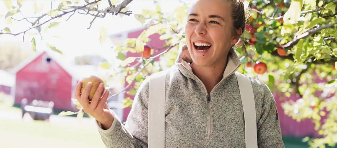 woman smiling holding apple - Self-Esteem Therapy in Austin, TX