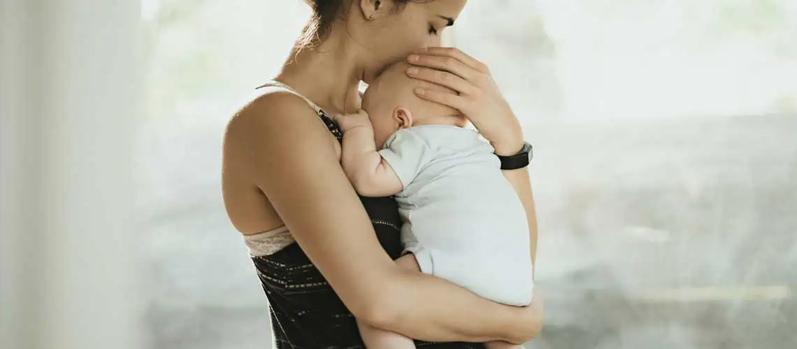 mom holding baby