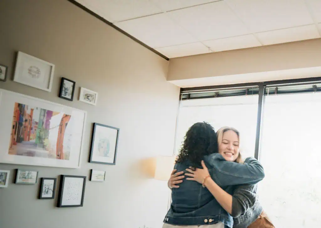 How to Stay Mentally Strong During Financial Uncertainty two people hugging