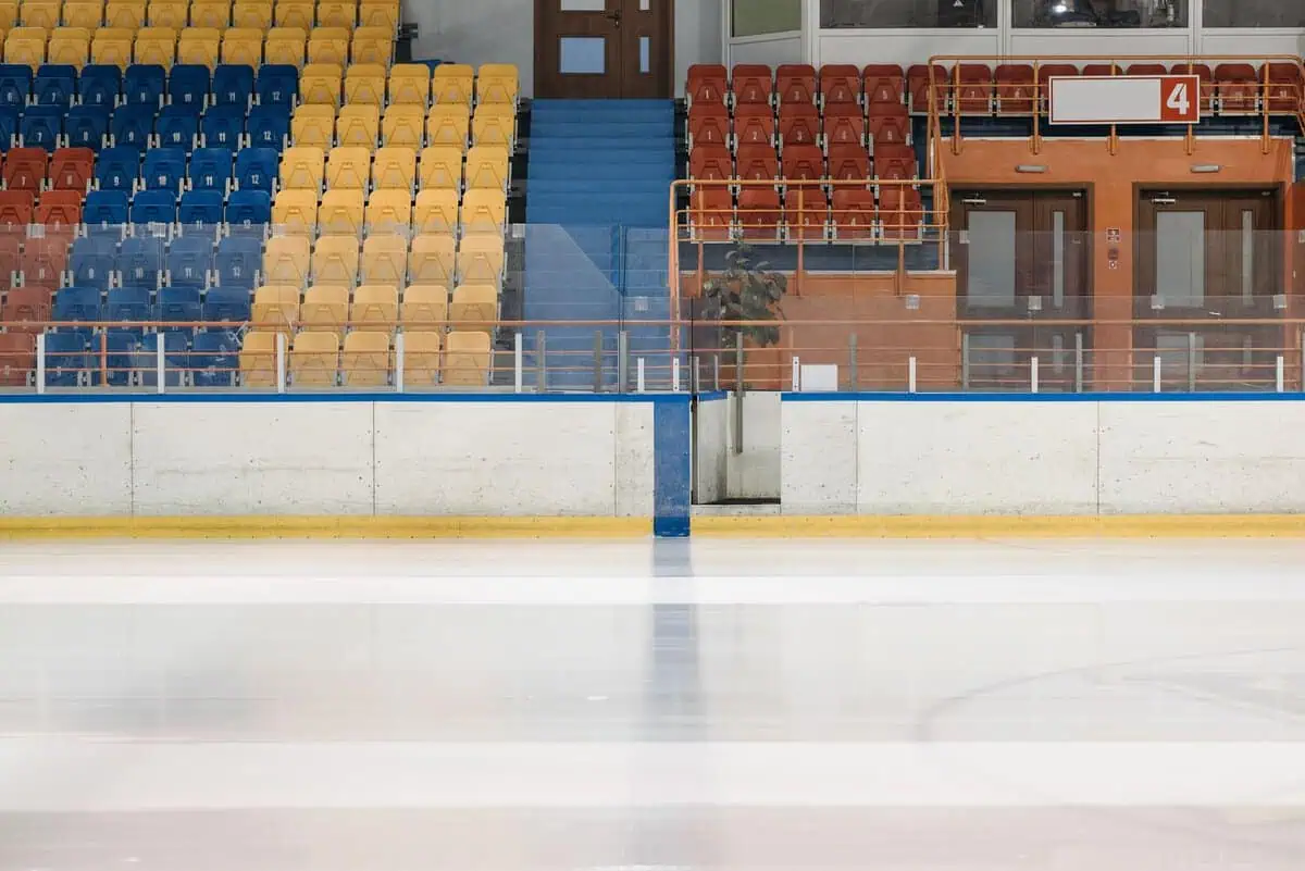Empty ice hockey rink evoking Heated Rivalry's mental health themes of isolation