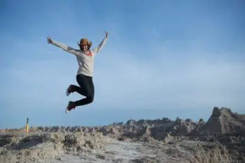 person jumping in desert/badlands