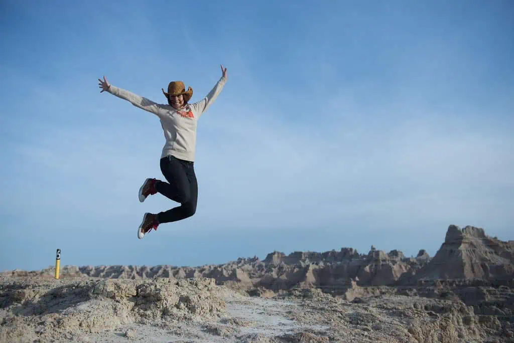 person jumping in desert/badlands