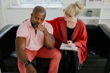 A therapist and client of different racial backgrounds talking during a multicultural therapy session