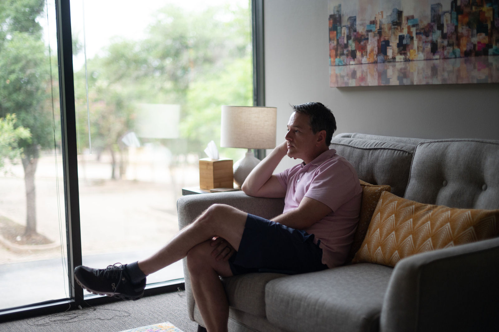 Aetna Therapist in Austin, TX 1 Man talking with his therapist by a sunny office window in Austin