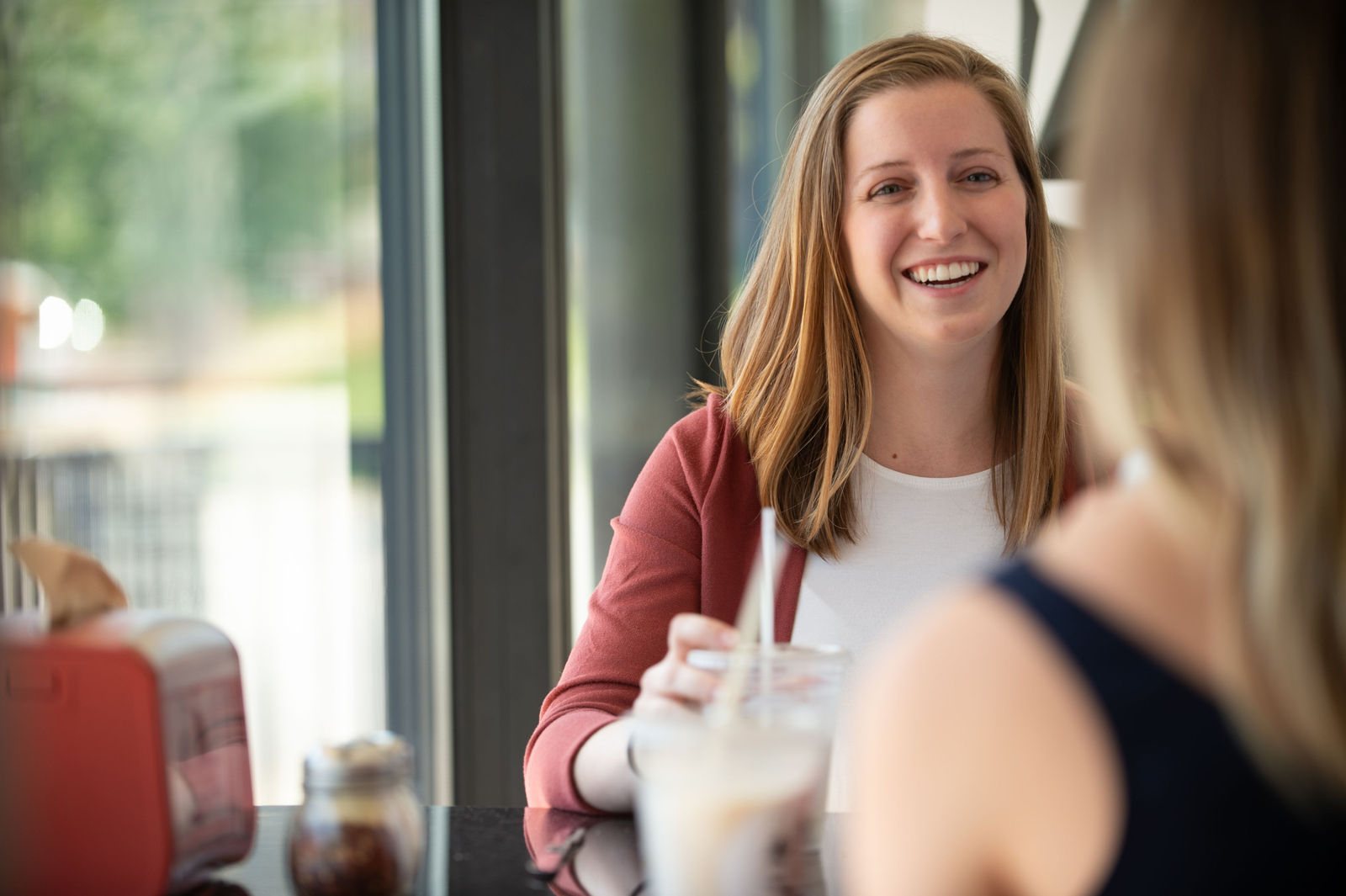 Harbor Health Therapist in Austin, TX 1 Two women talking and laughing over coffee
