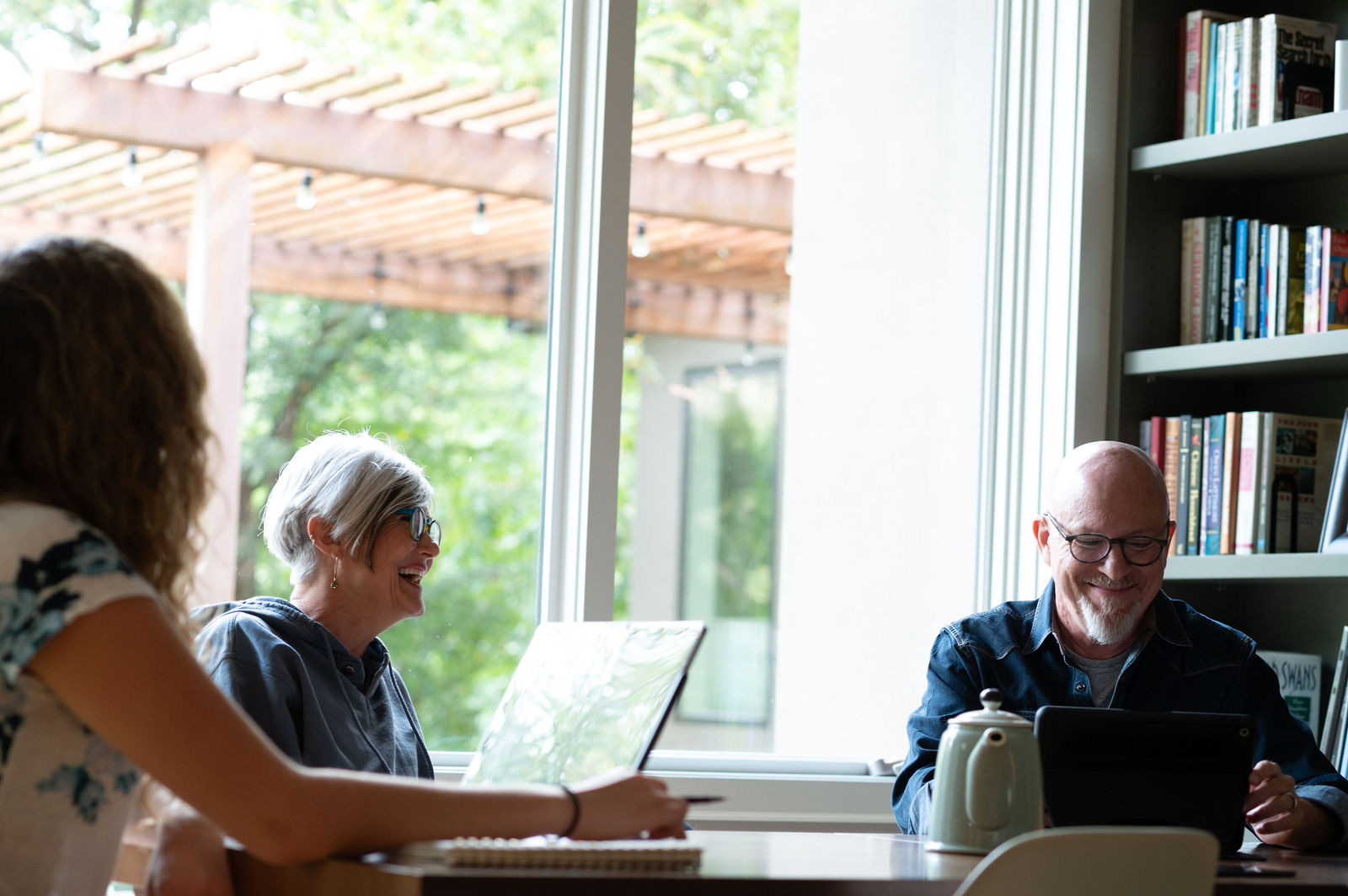 Sana Benefits Therapist in Austin, TX 1 Coworkers working together at a table near a bright window